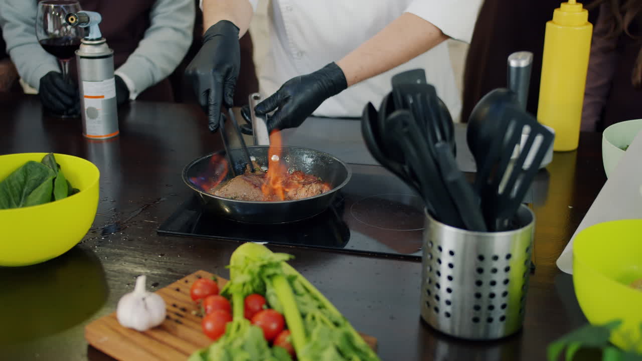 Chef cooking steak with flame