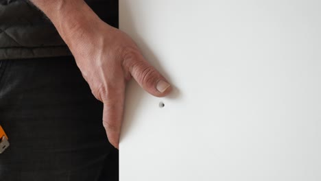 man holding a white board/panel