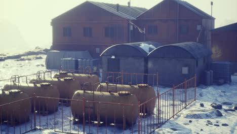 industrial storage facility in remote snowy landscape at dawn