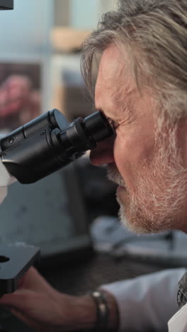 scientist using a microscope in a laboratory setting