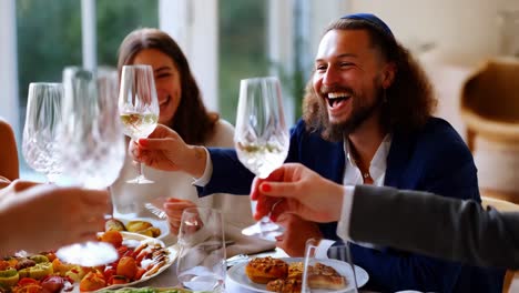 friends toasting wine at a celebratory dinner