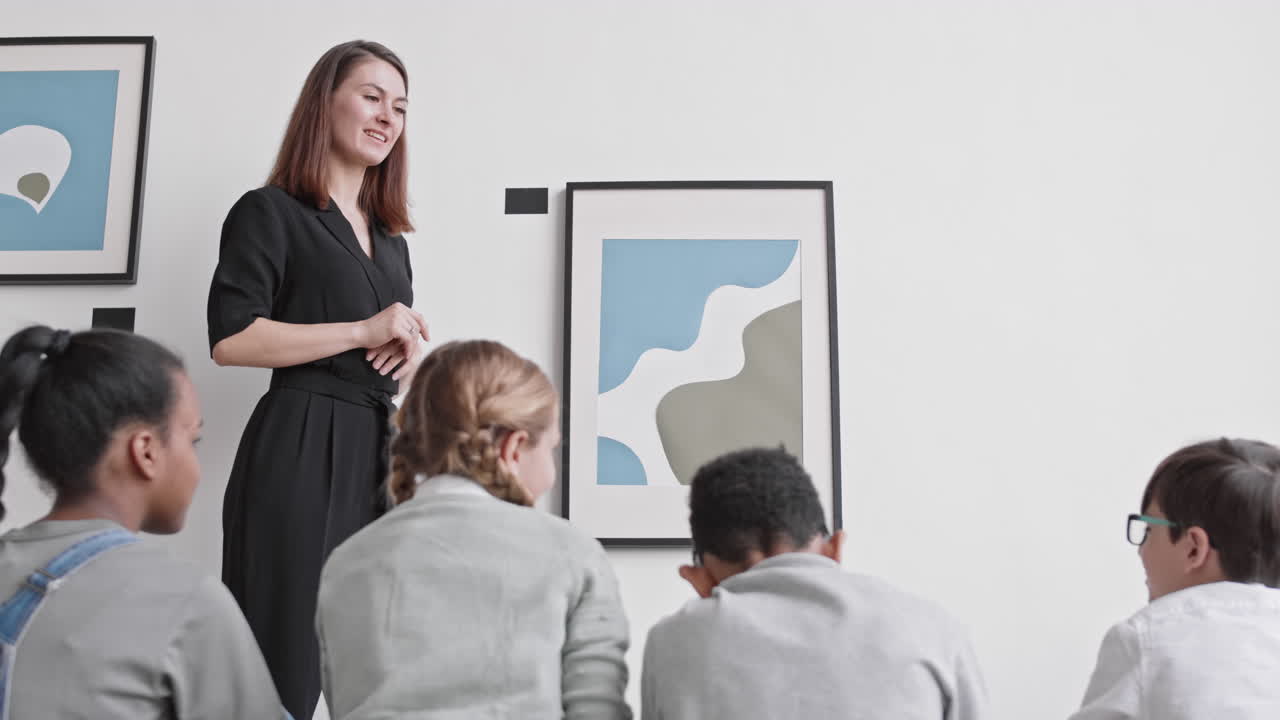 Museum Worker Presenting Painting to Kids