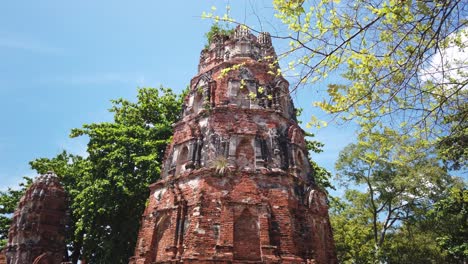 vertical pan shot: buddhist temple at the old the historic city of ayutthaya thailand