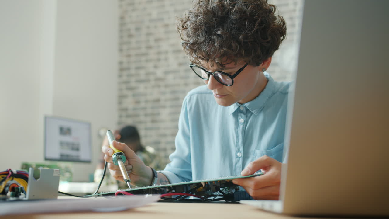 Woman repairing a circuit board