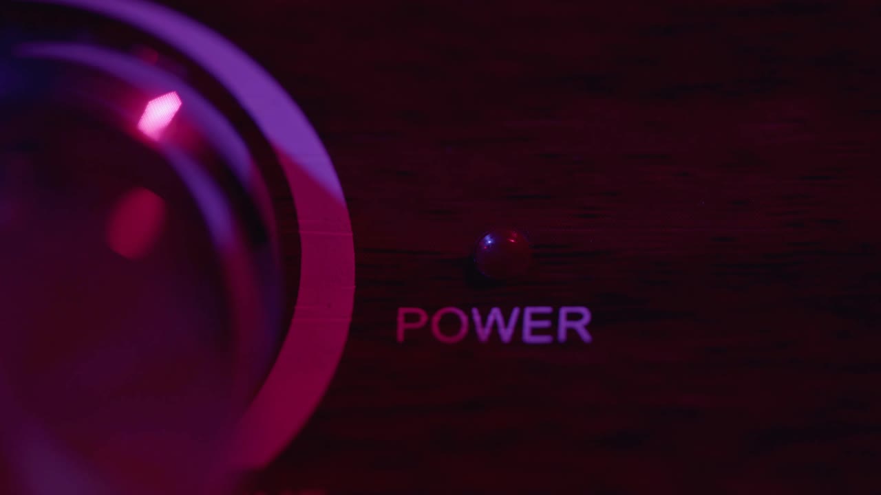 Finger Pressing Power Button Turning Red Indicator Light On and Off