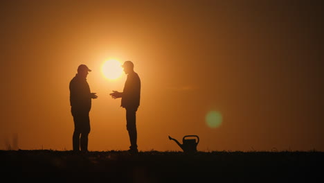 farmers talking at sunset