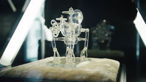 a glimmering transparent robot on display: exploring the fusion of art and technology through innovative design and intricate craftsmanship