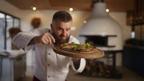 professional chef presenting pizza cuisine in italian food restaurant kitchen.