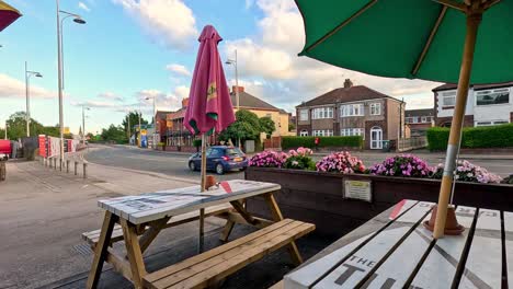 a quiet town square with benches and flowers