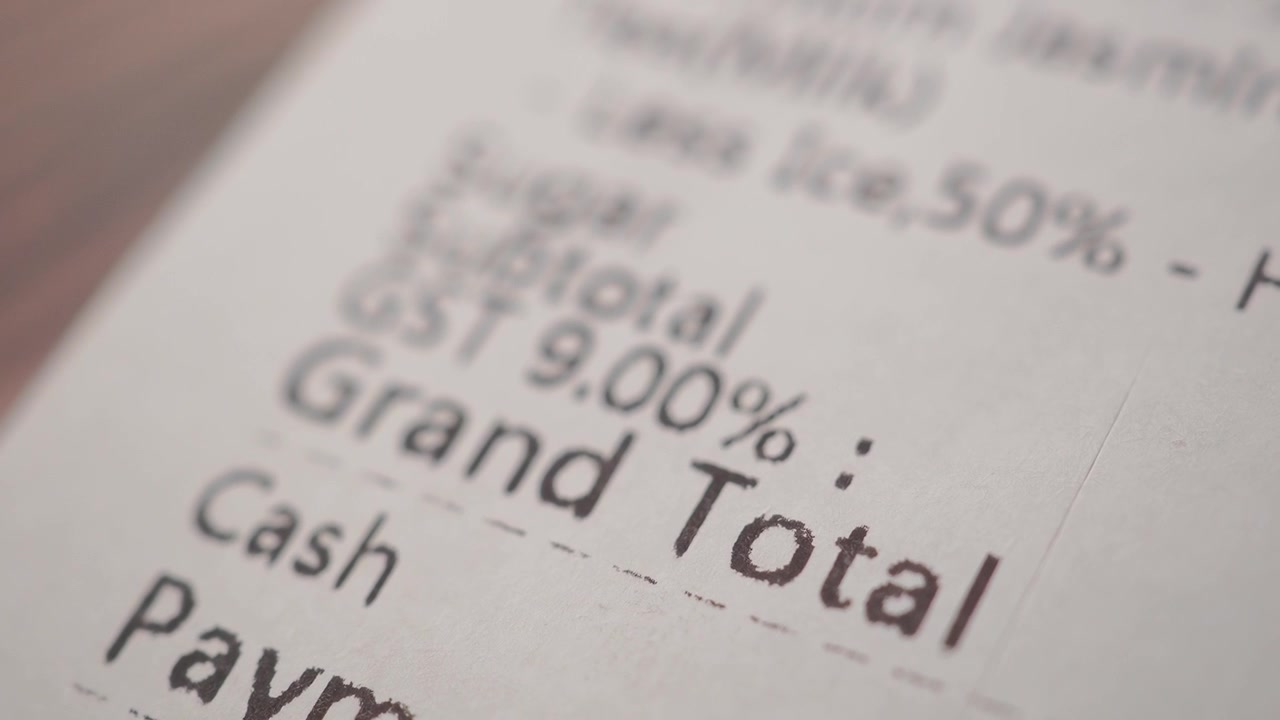 Close-up of a printed paper receipt showing grand total