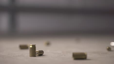 multiple bullet shells falling to the ground and bouncing