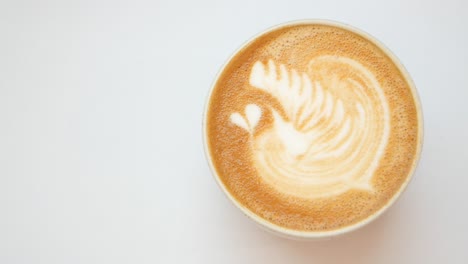 A-cup-of-late-coffee-with-flower-shape-design-on-top-at-cafe