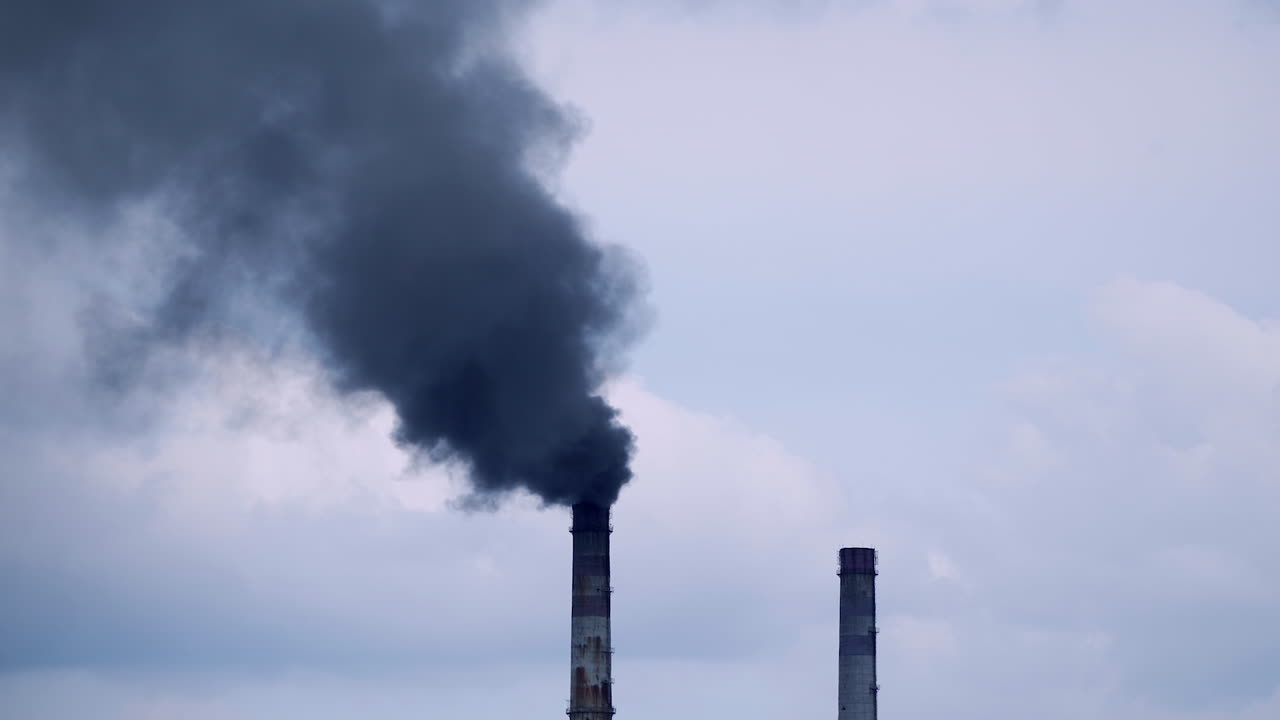 Factory pipe polluting air. Plant emits smoke and smog from the pipes