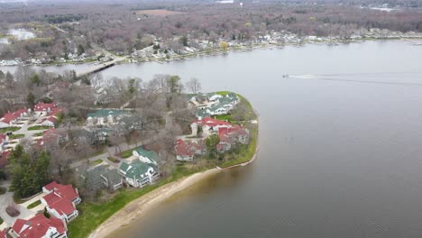 a boat travelling along spring lake in michigan, early spring