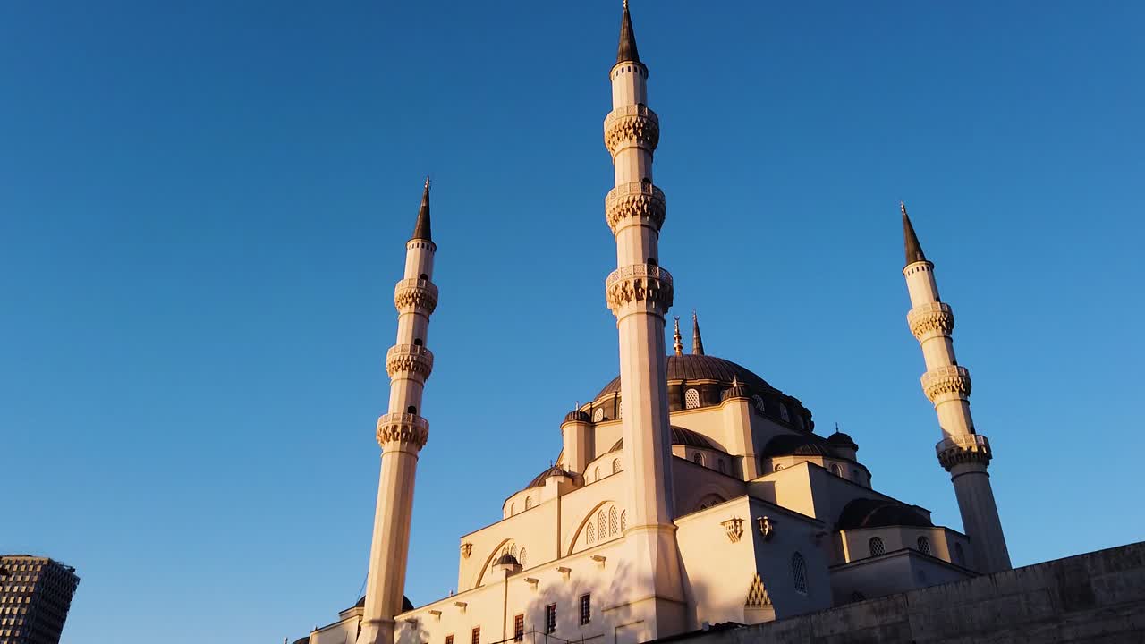 Panning shot of Namazgjah Mosque in Tirana with clear blue sky
