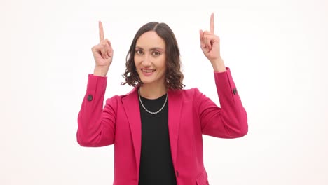 woman in pink blazer pointing upwards