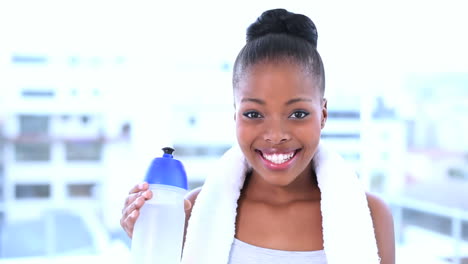 smiling model drinking water