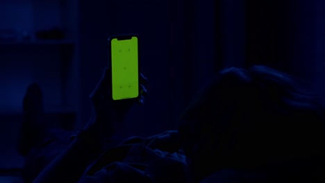 person looking at phone at night