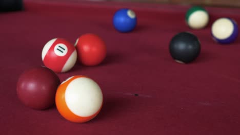 pool ball triangle being broken at the beginning of the game.