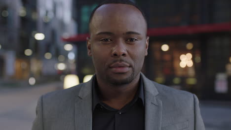 close up portrait of successful african american businessman thinking pensive turns head lookingat camera in city