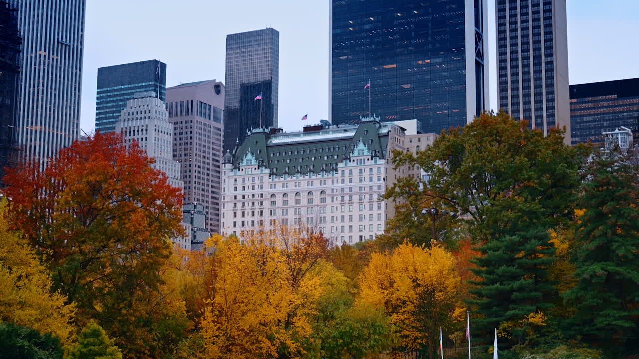 Beautiful autumn in Central Park, New York, USA. Modern skyscrapers at backdrop