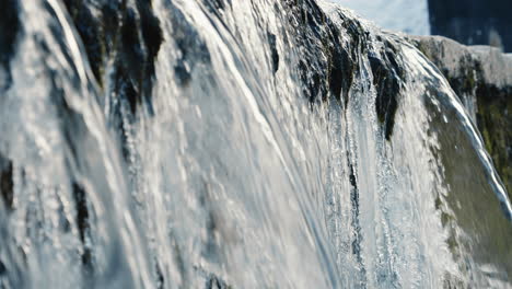 multiple-waterfalls-in-the-frozen-river,-close-up,-slow-motion