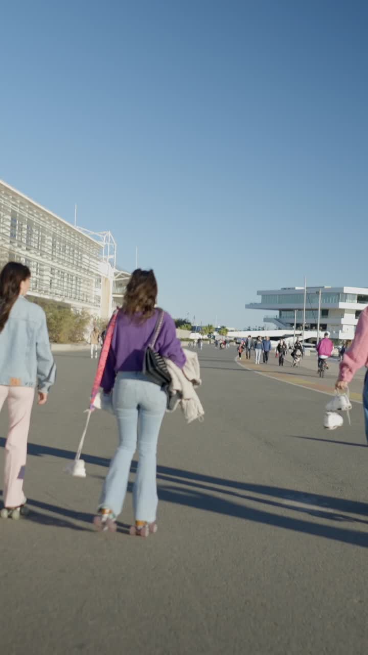 People Rollerblading and Walking Outdoors on a Sunny Day