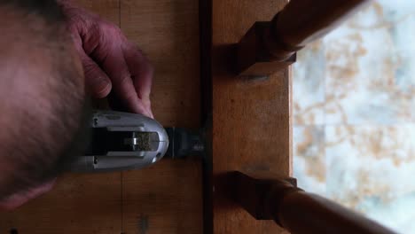 repairing a wooden chair leg with an oscillating multi-tool