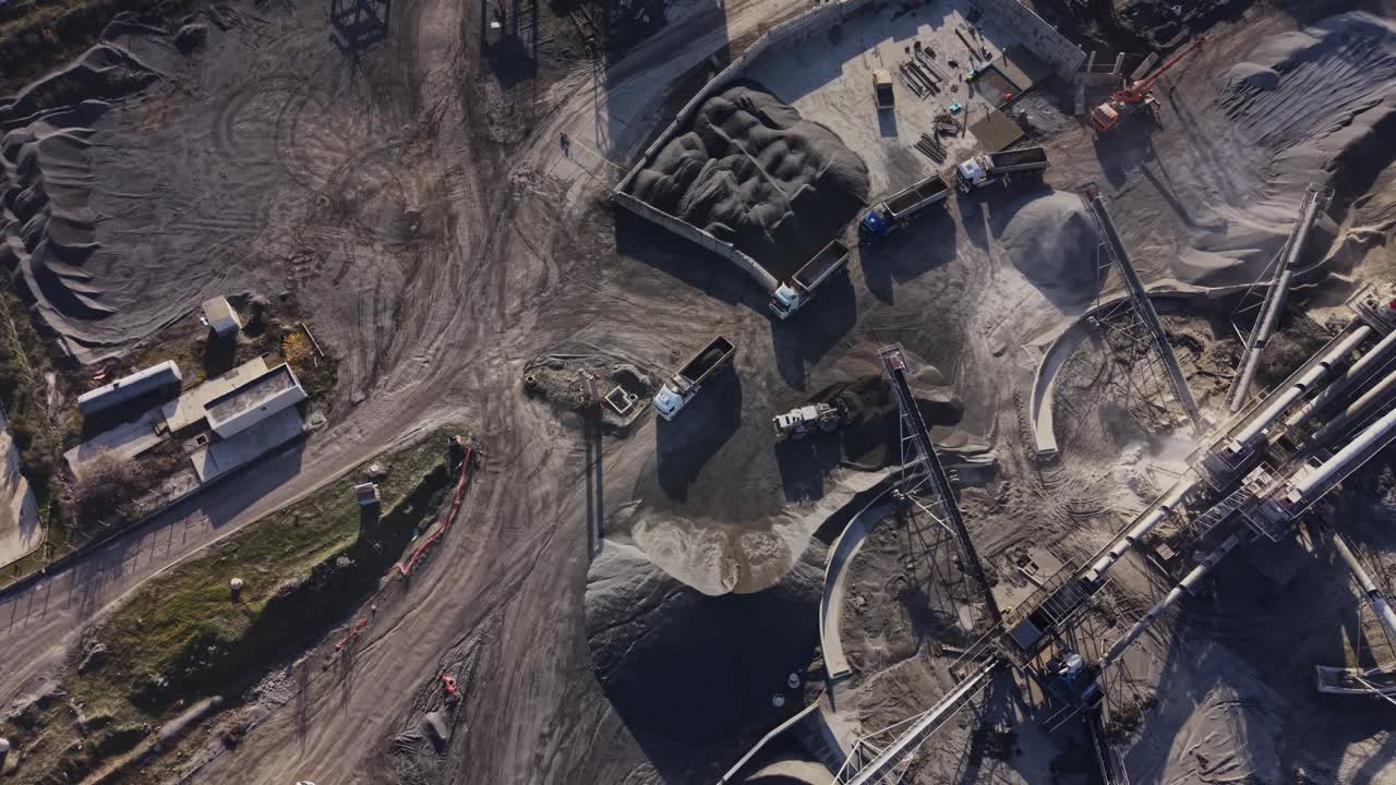 View of quarry with equipment and materials at mining site in daytime