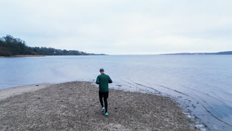 Runner-on-serene-beach-path-at-dusk-early-in-the-morning