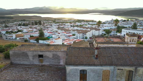 an aerial drone shot during sunrise of the town bornos at embalse de bornos in andalucia, spain