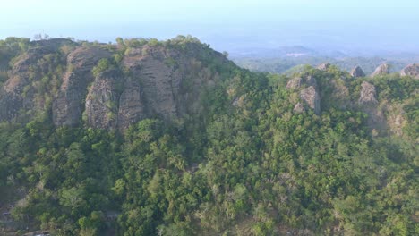 Aerial-view-of-huge-rock-mountain-with-towering-rock-spike-surface-on-the-top