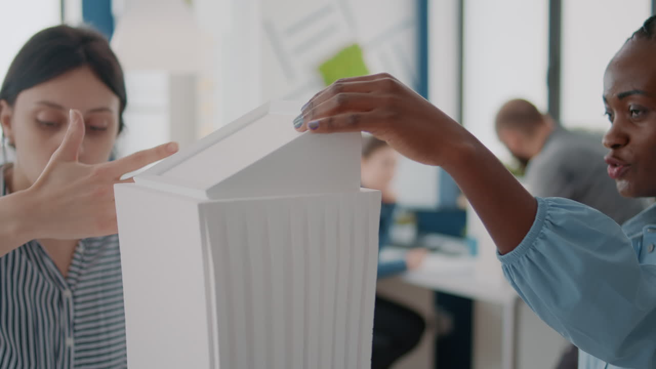 People discussing an architectural model
