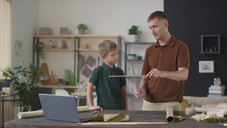 father and son learning woodworking together