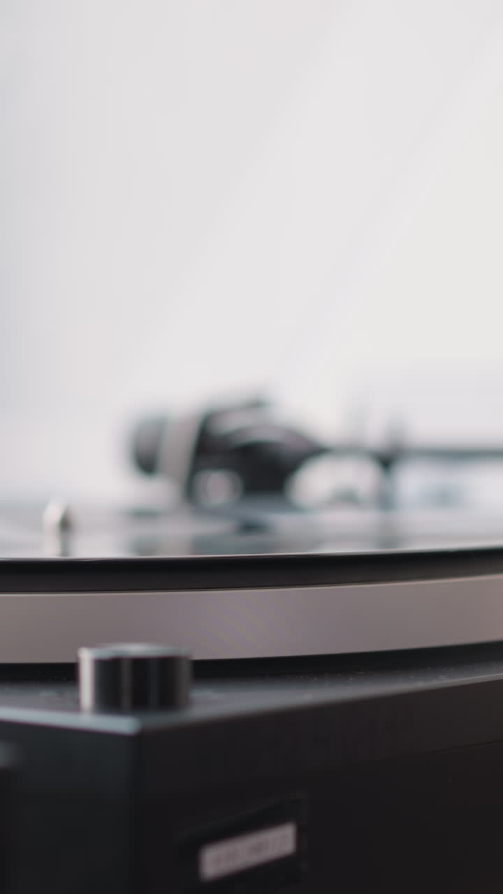 Hand of woman wiping vintage turntable closeup. Woman carefully wipes dust from turntable plate before putting disk with classical music. Nostalgia concept
