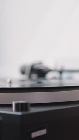 hand of woman wiping vintage turntable closeup. woman carefully wipes dust from turntable plate before putting disk with classical music. nostalgia concept