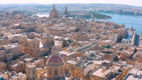 drone flying above the city of la valletta in malta panning and tilting up