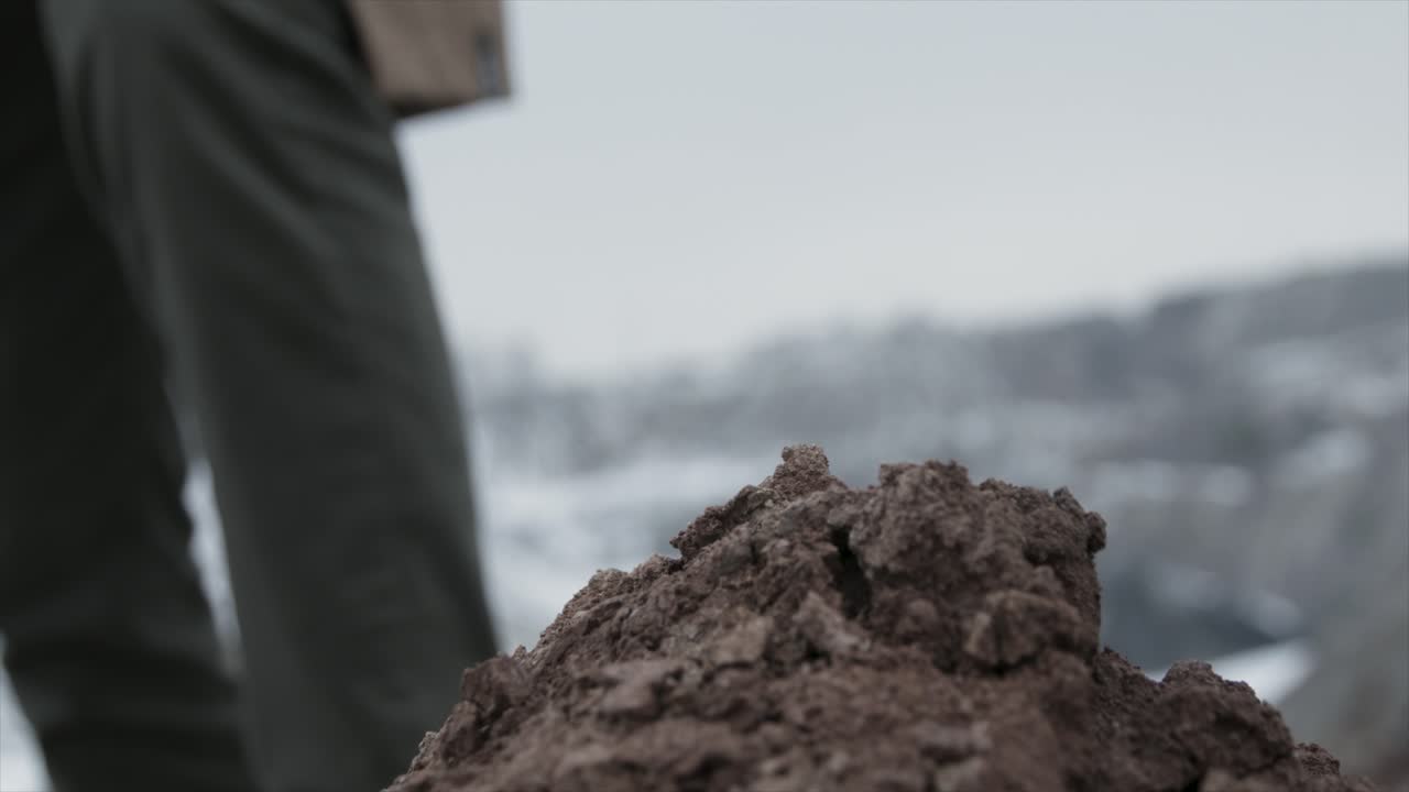 Person near a pile of dirt