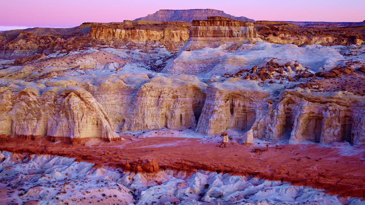 Drone footage soaring over colorful toadstool hoodoos with mesmerizing geological patterns.