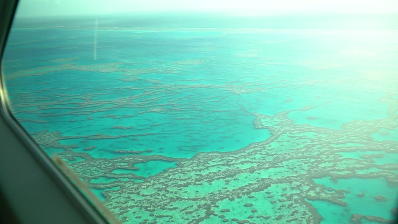 Stunning turquoise waters at Great Barrier Reef during sunrise, seaplane window view