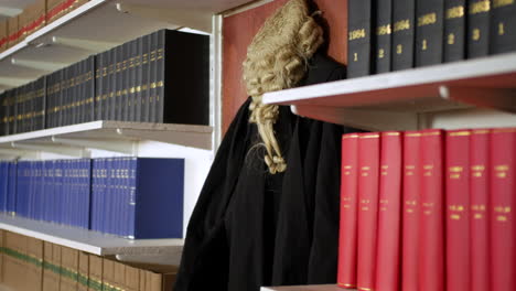 a judge's wig and gown hanging in the chamber of a courtroom law library