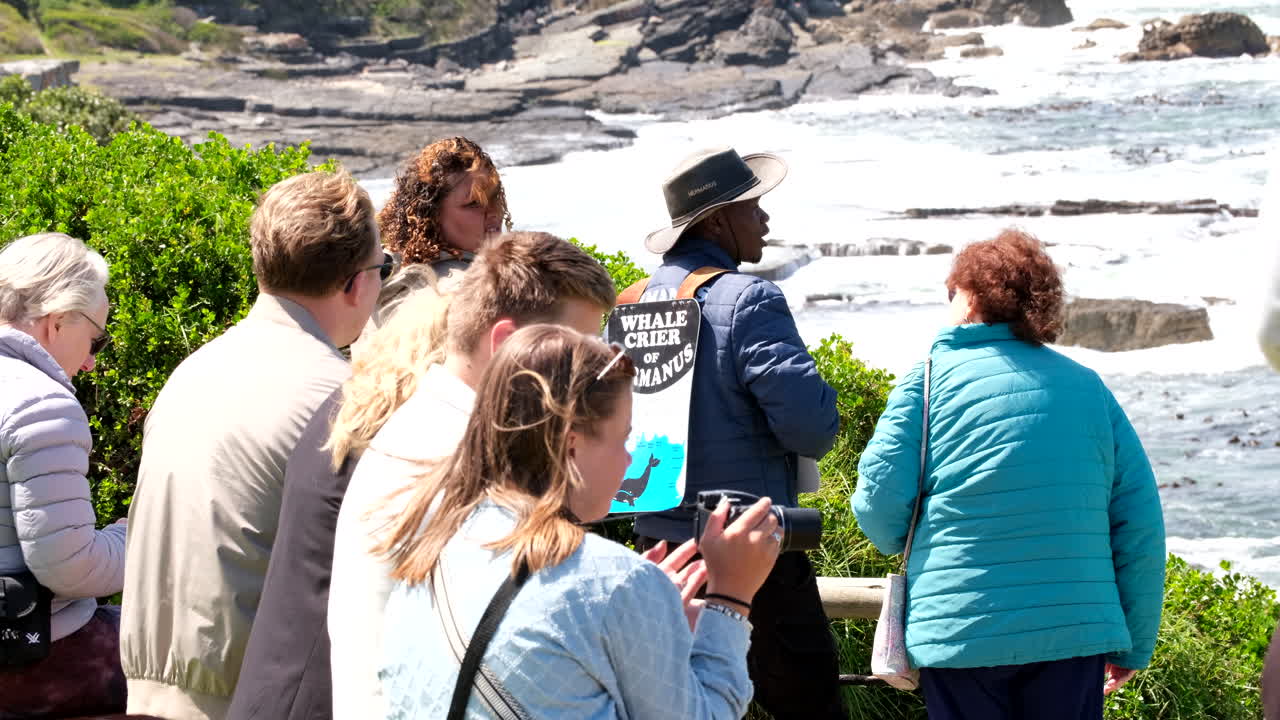 Famous Hermanus whale crier shares information about the whales with tourist