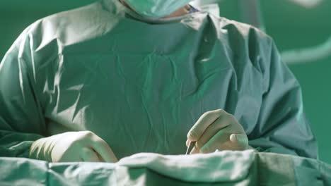 surgeon in operating room preparing for surgery