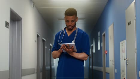 doctor using tablet in hospital hallway