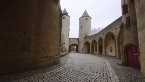 The-bailey-of-the-German's-Gate-castle-in-Metz,-France-lies-empty-in-the-handheld-shot