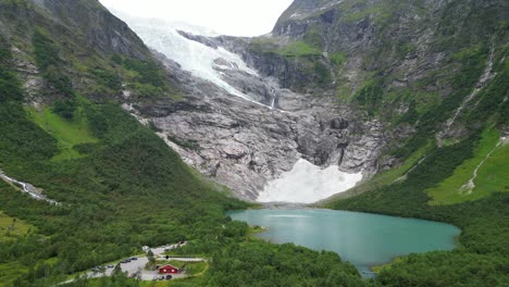 jostedalsbreen glacier norway - boyabreen viewpoint and turquoise blue glacial lake - aerial circling