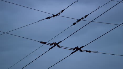 closeup trolleybus wires cloudy sky. electrical cables net for high voltage