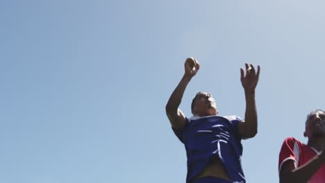 Camera-shutter-clicking-effect-against-two-male-soccer-player-jumping-to-win-the-ball