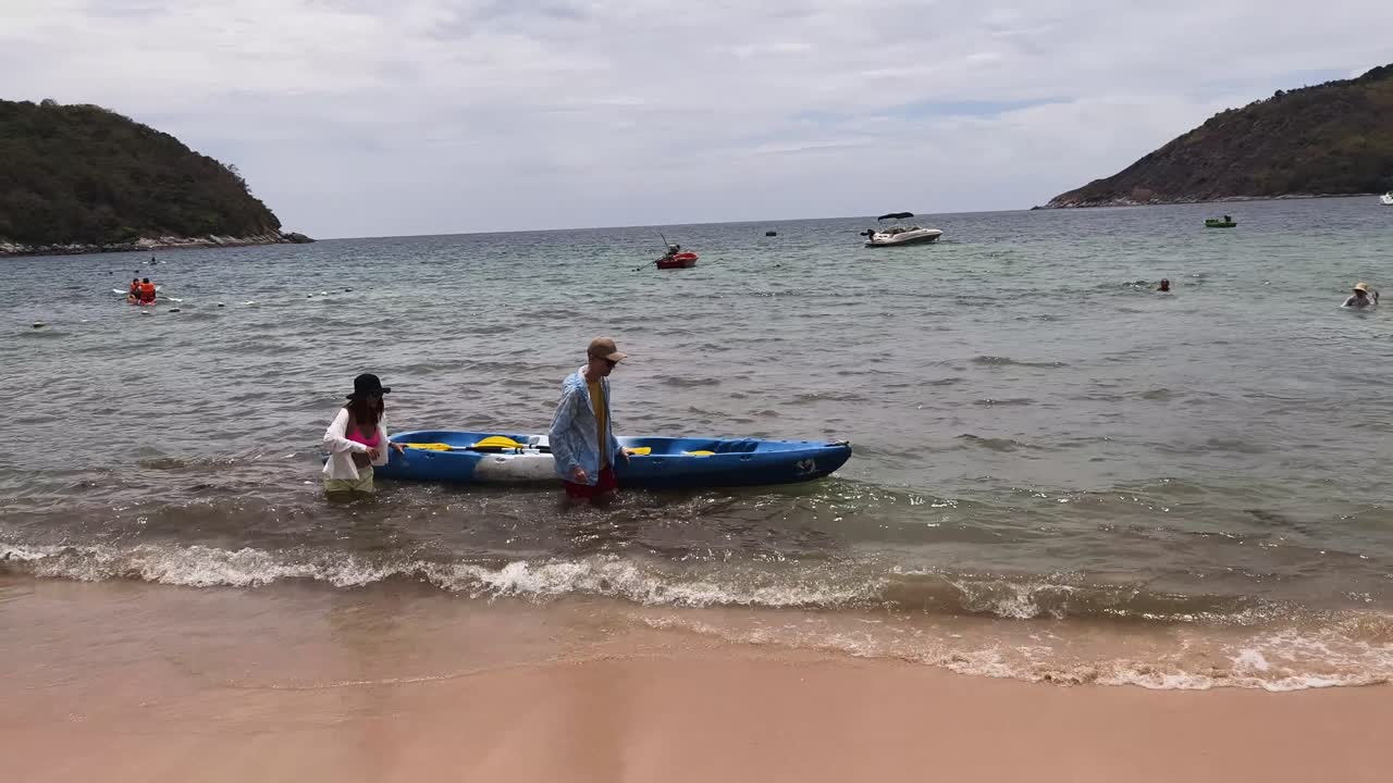 Couple Kayaking on a Tropical Beach