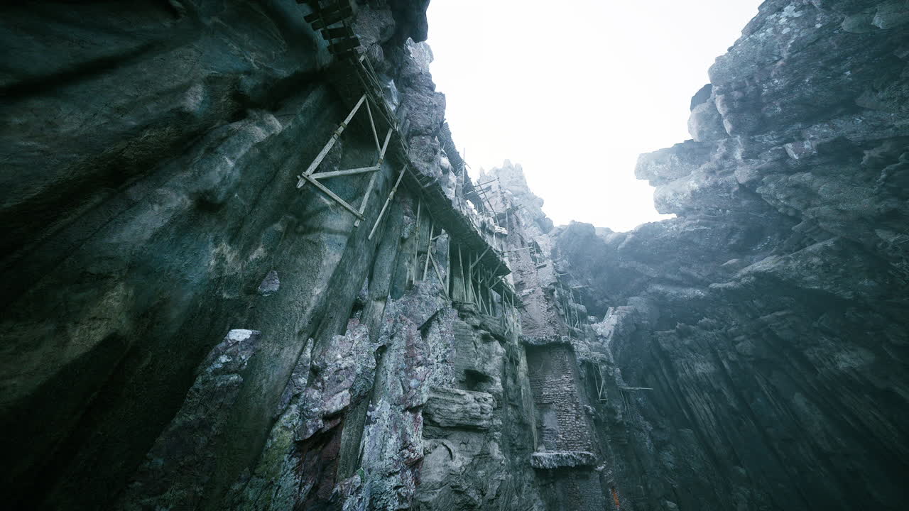 Vertical view of ancient cliffside structures in a rocky canyon landscape